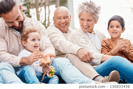 Bonding, happy and family laughing during a visit for love, care and happiness. Playing, interracial and grandparents, children and father in a garden for quality time, playful and cheerful together Bonding, happy and family laughing during a visit for love, care and happiness. Playing, interracial and grandparents, children and father in a garden for quality time, playful and cheerful together 130833456