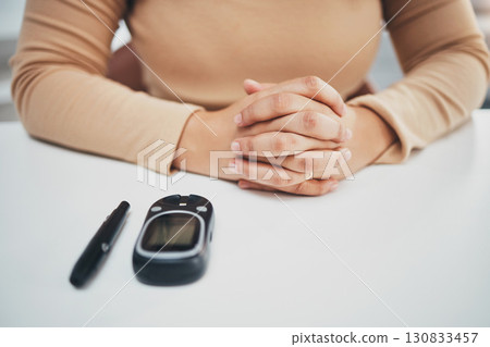 Hands, diabetes and glucose machine on table for woman with medical problem, self care or wellness. Monitor, glucometer or blood test of sugar level, healthcare or insulin for patient at desk in home Hands, diabetes and glucose machine on table for woman with medical problem, self care or wellness. Monitor, glucometer or blood test of sugar level, healthcare or insulin for patient at desk in home 130833457