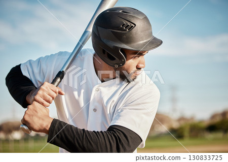 Baseball, bat and serious with a sports man outdoor, playing a competitive game during summer. Fitness, health and exercise with a male athlete or player training on a field for sport or recreation 130833725