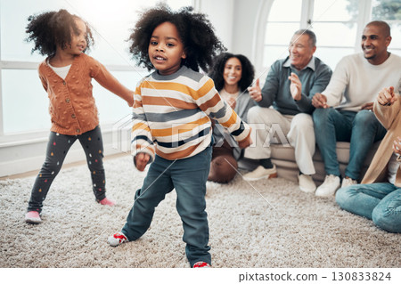 Big family, children dancing and living room with parents, grandparents or love with applause in home. Kids, men and women with dance, smile or happiness for brother, sister and together on holiday 130833824