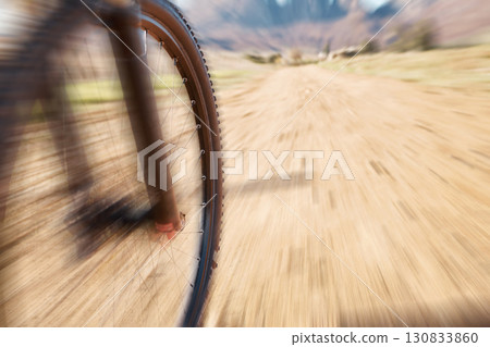 Cycling wheel, motion blur and fitness in nature, countryside and training of triathlon, sports and power. Closeup bicycle, speed and outdoor adventure for off road freedom, bike exercise and action Cycling wheel, motion blur and fitness in nature, countryside and training of triathlon, sports and power. Closeup bicycle, speed and outdoor adventure for off road freedom, bike exercise and action 130833860