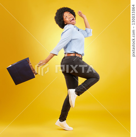 Bag, happy and black woman shopping, excited and celebrating sale in studio on yellow background. Discount, shopper and girl customer cheerful after boutique, retail or store deal posing isolated Bag, happy and black woman shopping, excited and celebrating sale in studio on yellow background. Discount, shopper and girl customer cheerful after boutique, retail or store deal posing isolated 130833864
