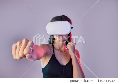 Vr, fitness and woman boxing in metaverse studio isolated on a purple background mockup. 3d exercise, virtual reality and female fighting or punching with futuristic technology for esports gaming. Vr, fitness and woman boxing in metaverse studio isolated on a purple background mockup. 3d exercise, virtual reality and female fighting or punching with futuristic technology for esports gaming. 130833932