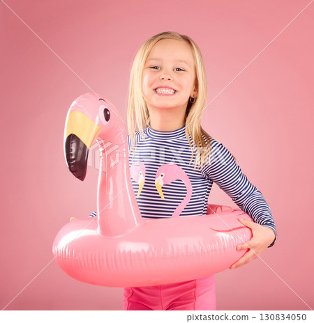 Safety, happy and portrait of girl and pool float for swimming, summer break and relax. Youth, funny and inflatable with child and flamingo ring for pool, smile and beach holiday on pink background 130834050