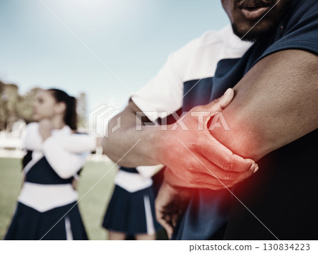 Cheerleader, sports or hand on elbow injury, pain or accident on field in game or training match. Red glow, fitness zoom or cheerleading male person with a medical emergency, joint or muscle sprain 130834223