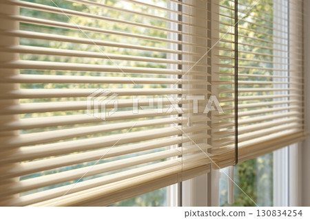 Roll textile jalousie. Modern beige window blinds. Blinds on large windows, sunlight. Motorized jalousie in the smart house. Modern window shutters, roller. Duo system day and night. Control strings. 130834254