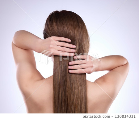 Back, beauty hands and hair care of woman in studio isolated on a gray background. Texture, cosmetics balayage and female model with salon treatment for healthy keratin, growth and straight hairstyle 130834331