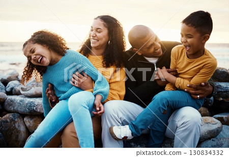 Laughing, family and relax at beach on vacation, holiday or trip at sunset outdoors. Love, care and happy, bonding and funny children, father and mother with laughter for tickling, joke or comedy. 130834332