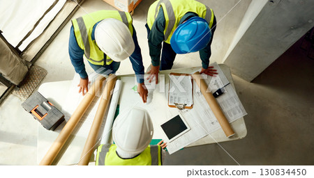 Team, blueprint and architect at construction site, engineer and infrastructure with contractor people top view. Floor plan, paperwork and collaboration with renovation and property development 130834450