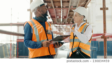 Construction, inspection and man with checklist talking to woman in engineering on site with scaffolding and building renovation. Contractor, survey and list of industrial maintenance safety rules 130834459
