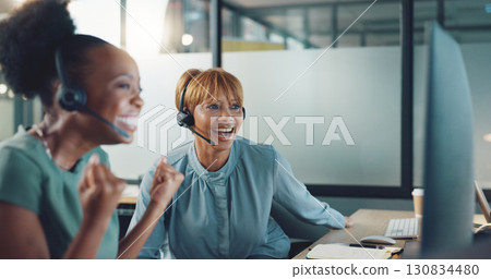 Business women, winner and call center computer for success, celebration and yes of goals, target or sales. Excited consultant or team surprise, wow and happy for bonus, news or announcement at night 130834480
