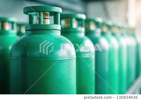 Green oxygen tanks. Bundle of gas cylinder and high pressure gauges, meter, valve. Many argon cylinders with compressed gas for industry, welding. Fuel manufacturing. Liquefied gas production, factory 130834636