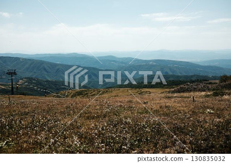 Ski lift chairs on Stara Planina mountain with panoramic view of green hills and valleys. Serbia country in summer season 130835032