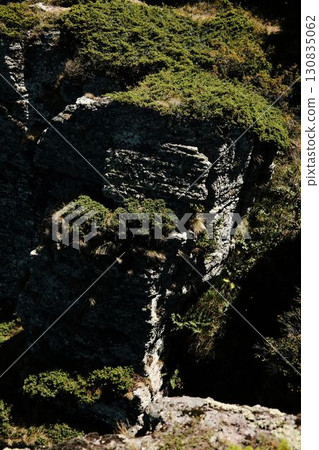 Close-up of massive rocky cliff with green vegetation on Stara Planina mountain. Serbia country 130835062