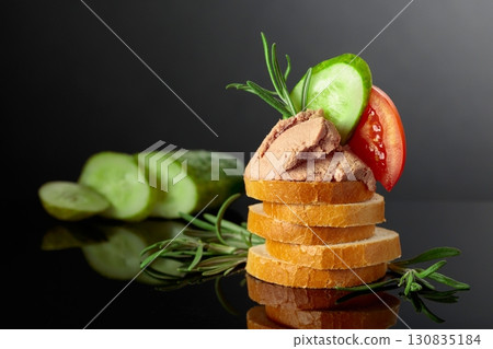 Bread slices with pate, tomato, cucumber, and rosemary. Bread slices with pate, tomato, cucumber, and rosemary. 130835184