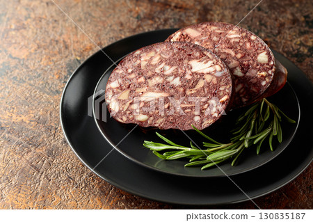 Blood sausage with meat offal accompanied by rosemary. Blood sausage with meat offal accompanied by rosemary. 130835187