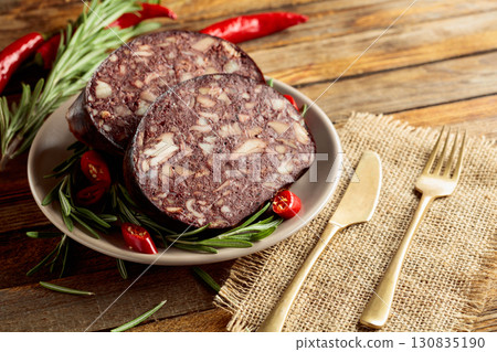 Black pudding or blood sausage accompanied by rosemary and red pepper. 130835190
