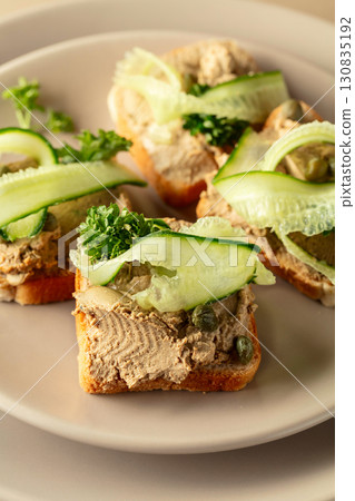 Toasts with pate on a beige background. Toasts with pate on a beige background. 130835192