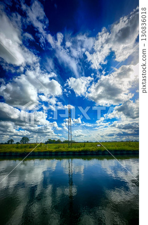 An absolutely stunning reflection of a beautifully cloudy sky over incredibly tranquil water An absolutely stunning reflection of a beautifully cloudy sky over incredibly tranquil water 130836018