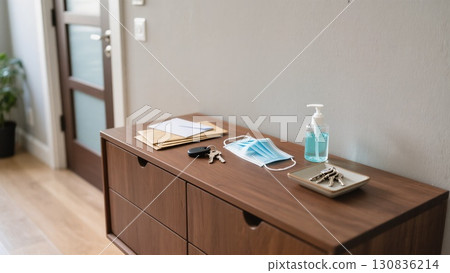 Entrance Area With Essential Items Like Masks, Keys, and Sanitizer During a Health-Conscious Period 130836214