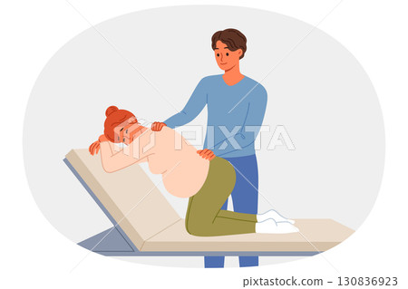 Man gives massage to pregnant woman kneeling on hospital bed waiting for labor to begin Man gives massage to pregnant woman kneeling on hospital bed waiting for labor to begin 130836923