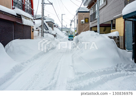 【青森】雪國生活，大雪紛飛。住宅區道路的雪景。道路狹窄，卡車小心翼翼地行駛。 130836976