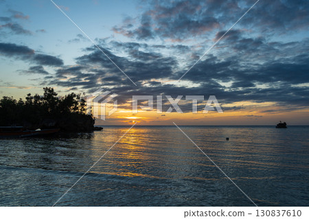 Sunset on Lia beach, Waleakodi Island, Togian archipelago, Sulawesi, Indonesia 130837610