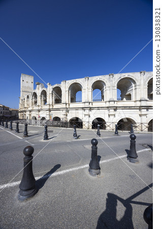 Arles Arena casting shadows on bollards in Provence, France 130838321