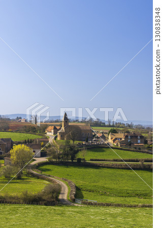 La Chapelle sous Brancion in Bourgogne Franche Comte, France, showing its church and cemetery under blue sky 130838348