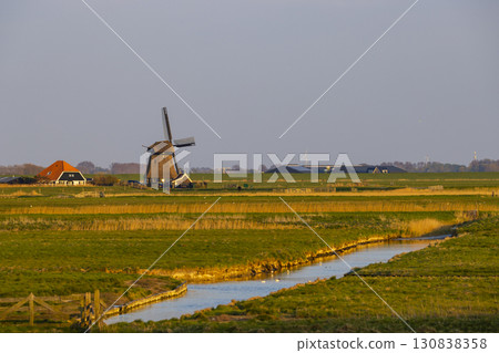 Traditional Dutch windmill standing in the countryside of Schoorl, Netherlands Traditional Dutch windmill standing in the countryside of Schoorl, Netherlands 130838358