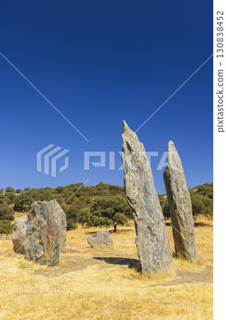 Megalithic Dolmen of the Sierra de la Granada in Rosal de la Frontera, Spain, standing tall under blue sky 130838452