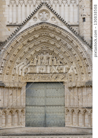 Intricately carved entrance of Poitiers Cathedral showcasing religious scenes and architectural details in Nouvelle Aquitaine, France 130838508