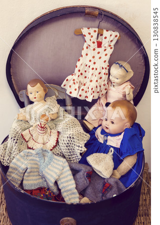 Vintage dolls and clothes resting in an old suitcase in Jaromerice nad Rokytnou, Czechia Vintage dolls and clothes resting in an old suitcase in Jaromerice nad Rokytnou, Czechia 130838545