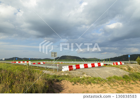 Red and white plastic road barriers at the end of the D11 highway on the border between Poland and the Czech Republic near Lubawce and Kralovec Red and white plastic road barriers at the end of the D11 highway on the border between Poland and the Czech Republic near Lubawce and Kralovec 130838583