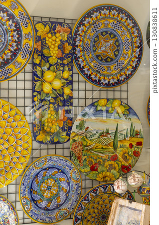 Traditional Italian ceramics with vibrant colors and detailed patterns, showcased in a shop in Assisi, Umbria 130838611
