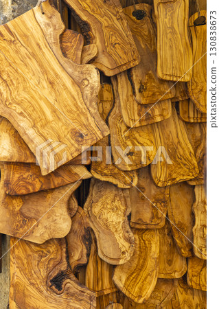 Olive wood chopping boards hanging in a store creating a beautiful pattern Olive wood chopping boards hanging in a store creating a beautiful pattern 130838673