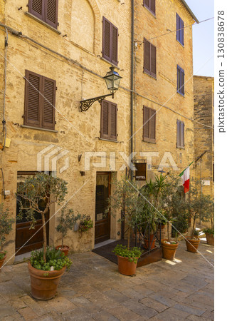 Charming Hotel in Tuscany with Potted Plants and Italian Flag 130838678
