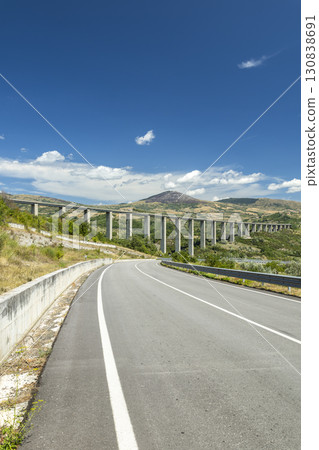 Highway winding through the valley with a viaduct in Agnone, Molise, Italy Highway winding through the valley with a viaduct in Agnone, Molise, Italy 130838691
