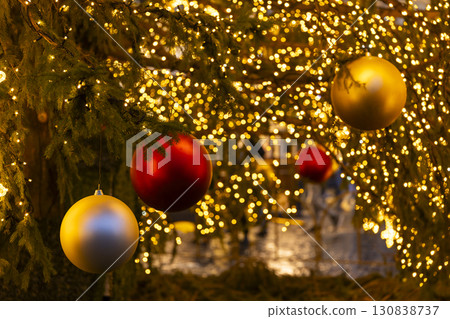 Christmas tree decorated with colorful balls and glowing lights celebrating holidays Christmas tree decorated with colorful balls and glowing lights celebrating holidays 130838737