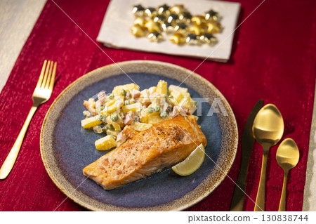 Salmon with Russian Salad and Lemon Slice on Christmas Table Setting 130838744