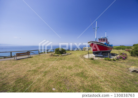 Red fishing boat overlooking the Cantabrian Sea in Cudillero, Asturias, Spain 130838763