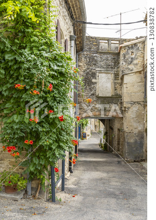 Picturesque alley with blooming flowers in Taulignan, France 130838782