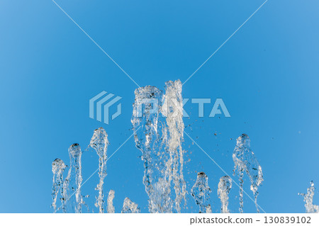 Splashes and jets of water against light background. Splashes and jets of water against light background. 130839102