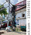 A unique Southeast Asian landscape photo of the intricately tangled electric wires and poles seen on the streets of Phnom Penh, Cambodia 130841401