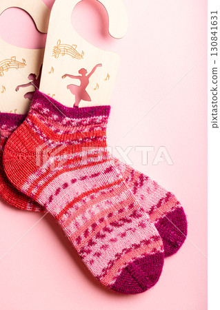 Knitted wool socks in vibrant pink and purple hues, showcasing intricate patterns and textures 130841631