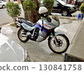 The retro and tasteful Honda vintage Transalp 600V motorcycle stands on a street corner in Phnom Penh, Cambodia. 130841758