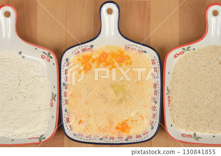 Beaten eggs, flour, and breadcrumbs for breading 130841855