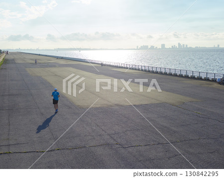 A man running on the seafront embankment of Shin-Urayasu Park in summer 130842295