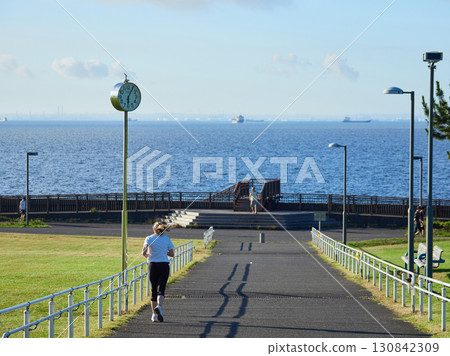 A foreign woman running in Shin-Urayasu Park in summer 130842309