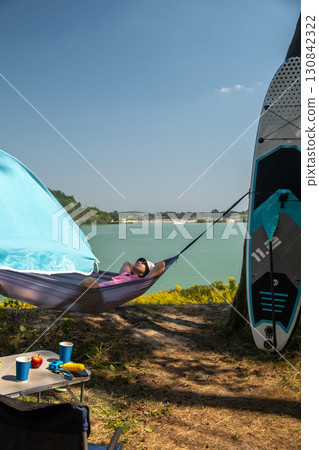 Relaxing in a Hammock by the Lake Relaxing in a Hammock by the Lake 130842322
